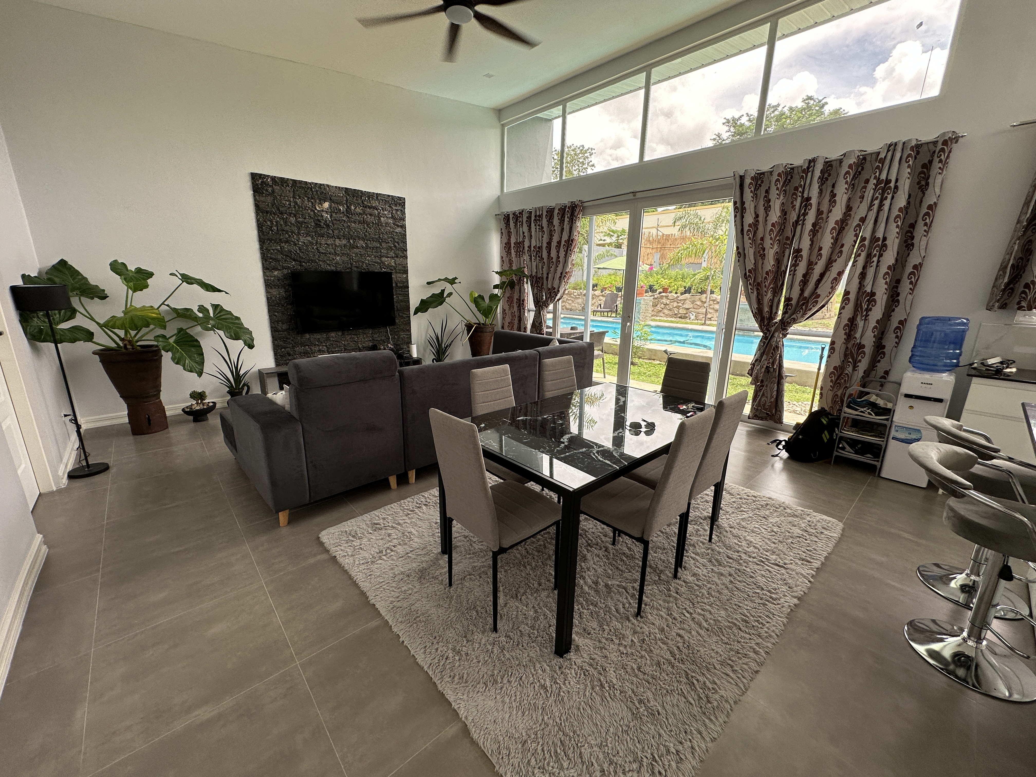 Open living and dining hall looking through to the pool