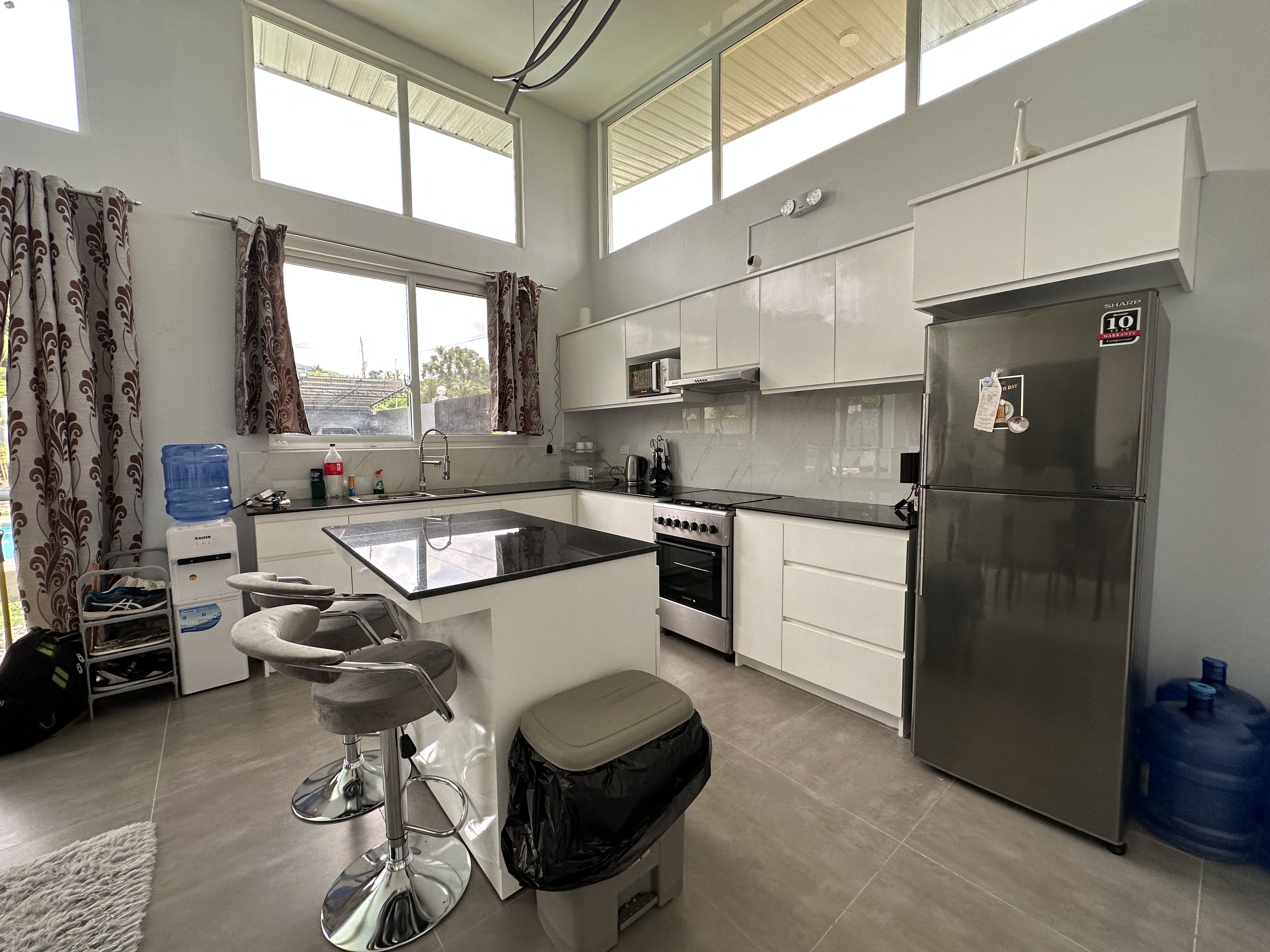 Kitchen with island and high windows